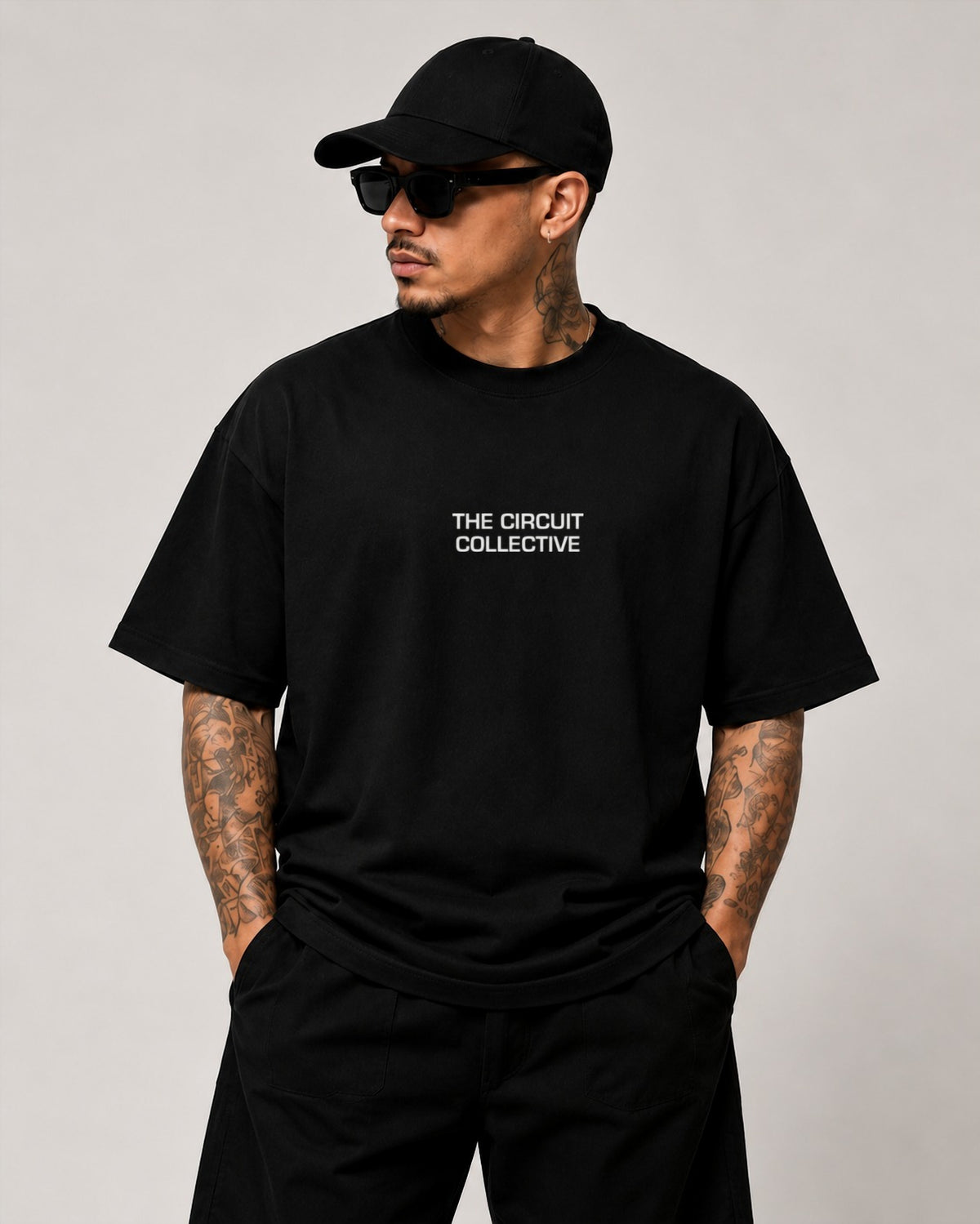 Circuit 001 Detailed tee in black, worn from the front: The Circuit Collective wordmark in white on the chest